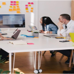 : A team in an office discussing intelligent search during a meeting